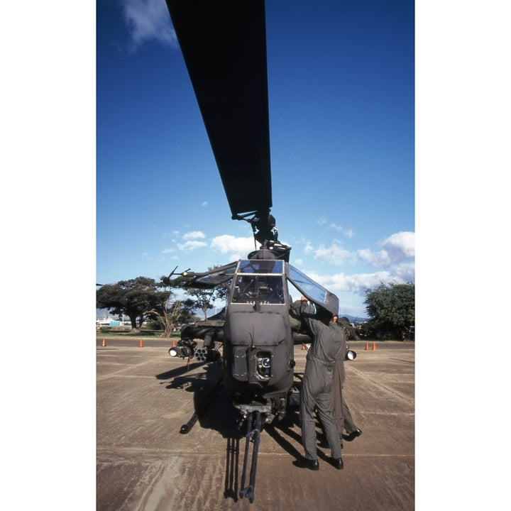 Air crewmen secure an AH-1 Cobra attack helicopter Poster Print Image 1