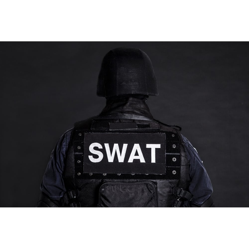 Special weapons and tactics team officer on black background shot from behind. Poster Print by Oleg Zabielin/Sto Image 1