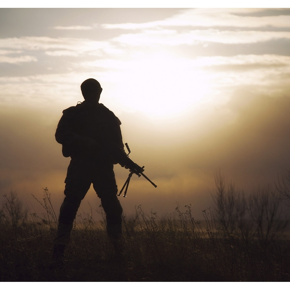 Silhouette of U.S. Marine with rifle against the sunset. Poster Print by Oleg Zabielin/Stocktrek Images Image 1