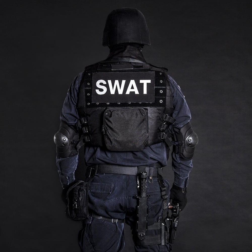 Special weapons and tactics team officer on black background shot from behind. Poster Print by Oleg Zabielin/Sto Image 1