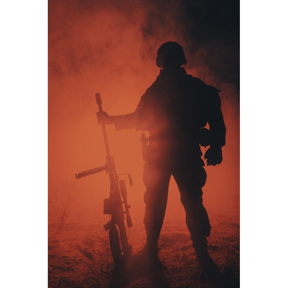 Backlit silhouette of Army sniper with large caliber rifle standing in the fire and smoke. Poster Print by Oleg Zabielin Image 1