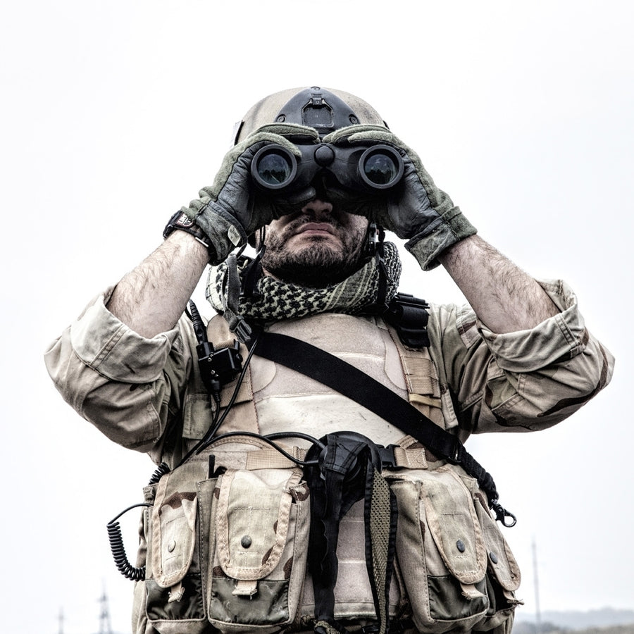 Navy SEAL scout looking through binoculars to observe terrain and search for enemy targets. Poster Print by Oleg Zabieli Image 1