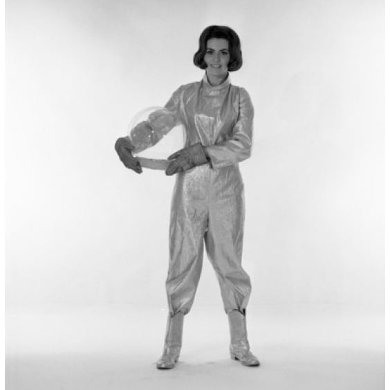 Studio portrait of female astronaut holding helmet Poster Print Image 1