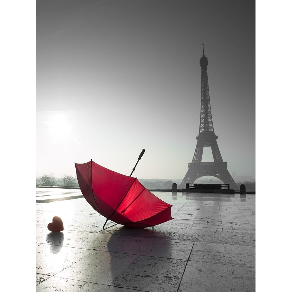 Two umbrellas next to the Eiffel tower Poster Print by Assaf Frank-VARPDXAF201203161331C07 Image 1