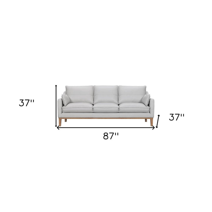 87" Gray Leather Sofa And Toss Pillows With Brown Legs Image 12